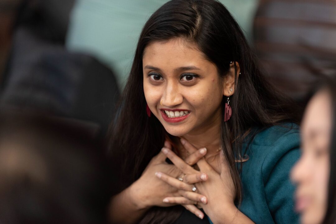 Photo of person looking excited at event.
