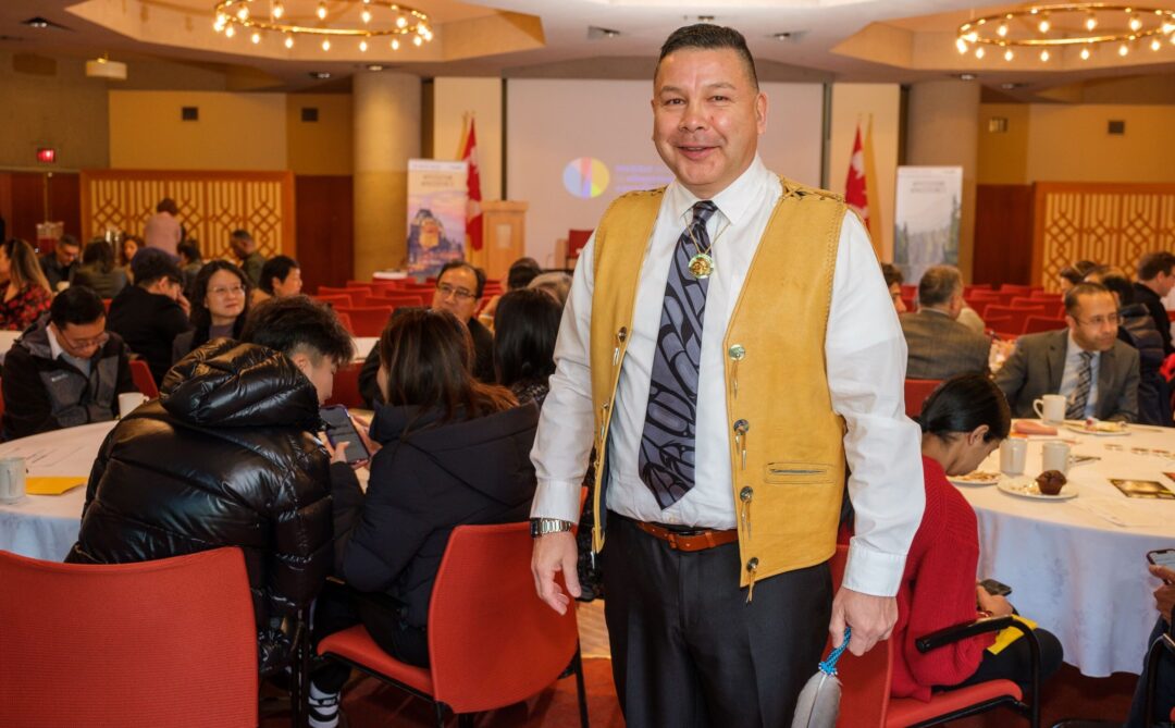 Jamie Thomas standing at citizenship ceremony.