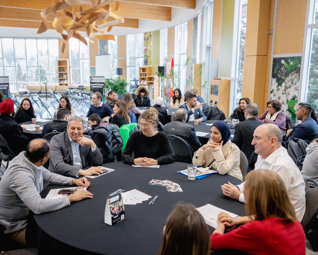 Groups of people sitting around tables during ICC's roundtable discussions.