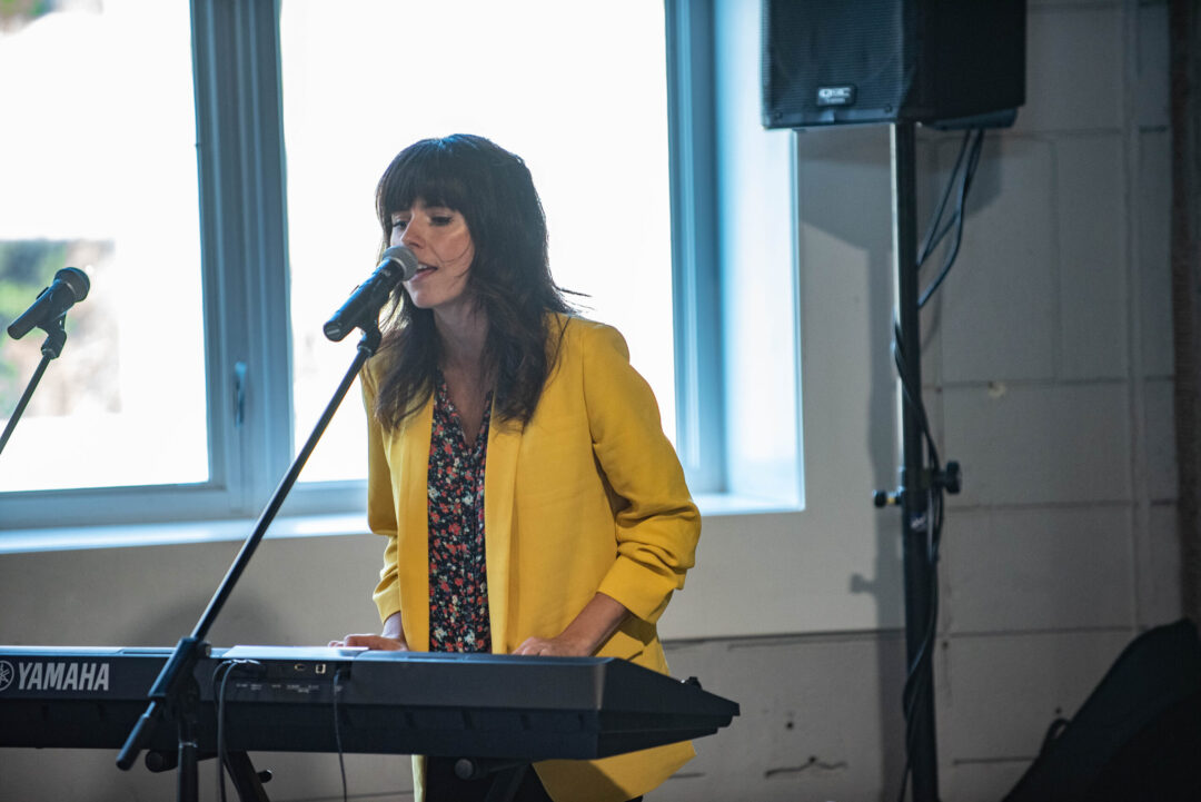 Ellie Heath performing on a keyboard.