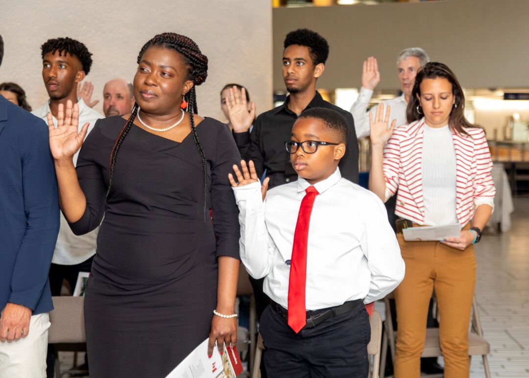 People taking the oath of citizenship at a Canadian Citizenship ceremony.