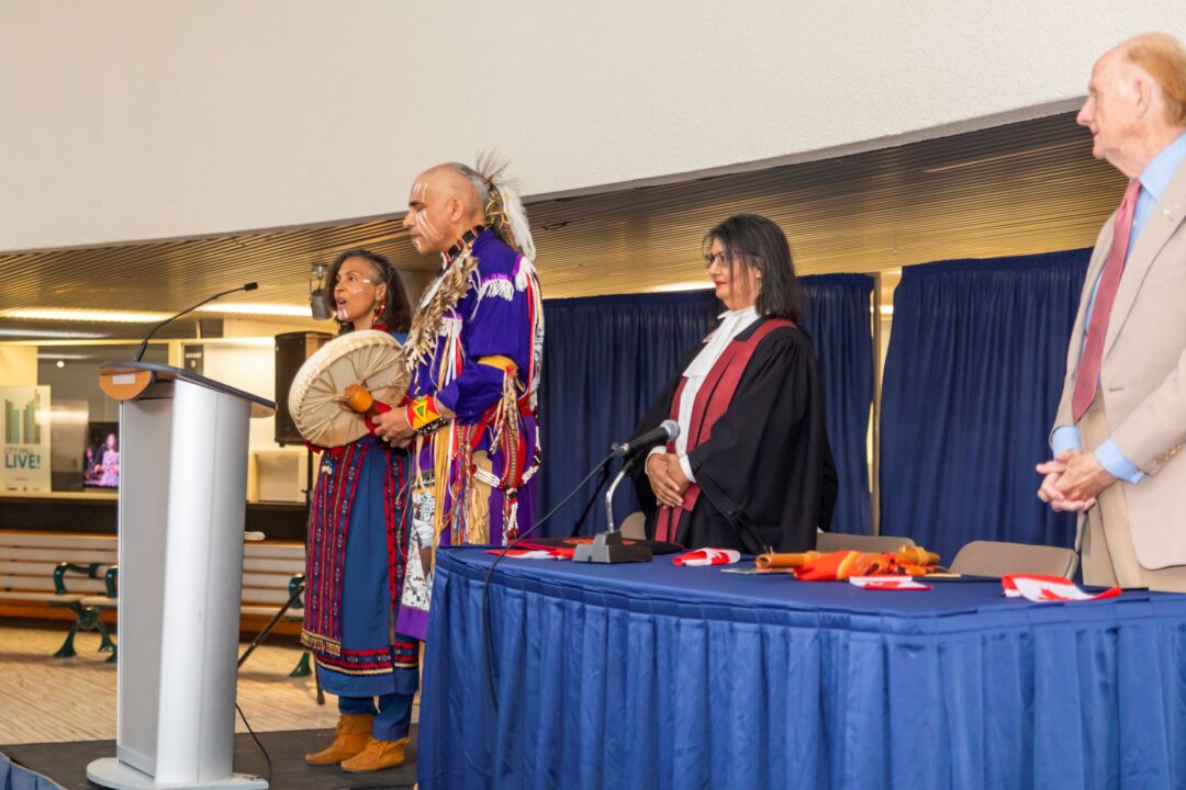 The Roberts family performing in Indigenous regalia.