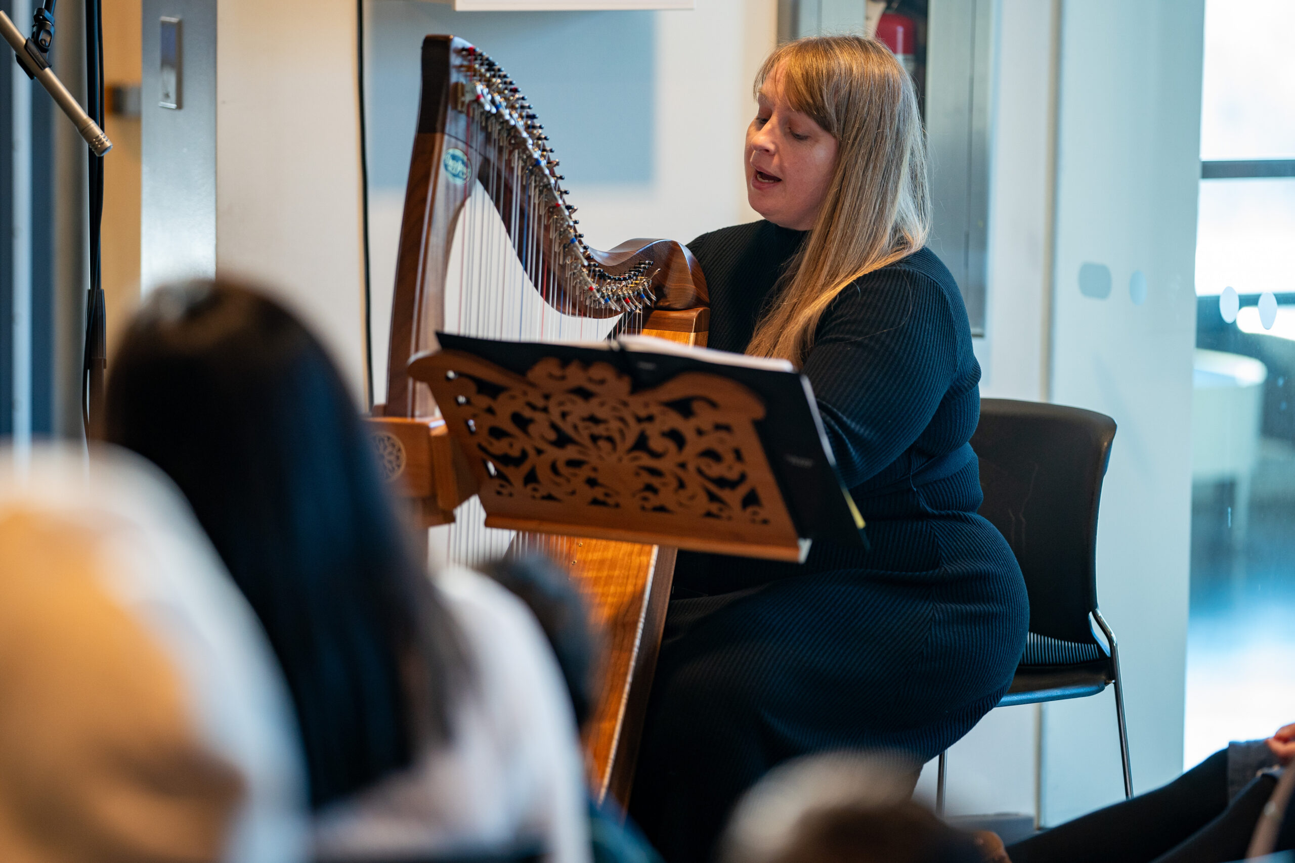 Harpist Adria Jackson playing the harp for the new Canadians